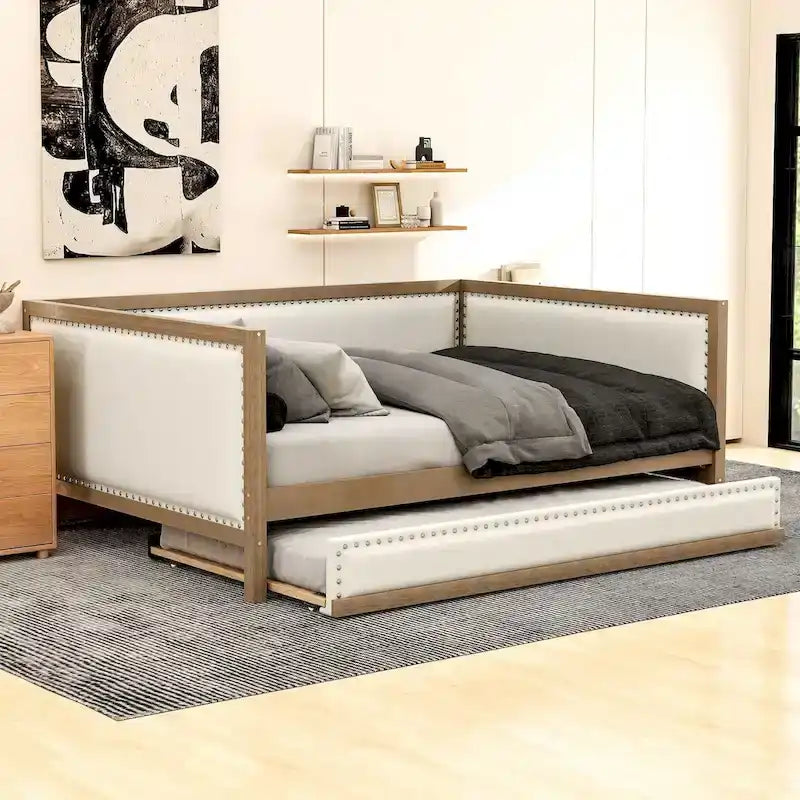 Letto a una piazza e mezza imbottito con letto estraibile e decorazione con borchie