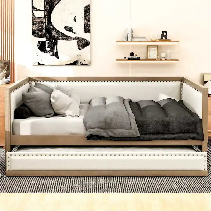 Letto a una piazza e mezza imbottito con letto estraibile e decorazione con borchie